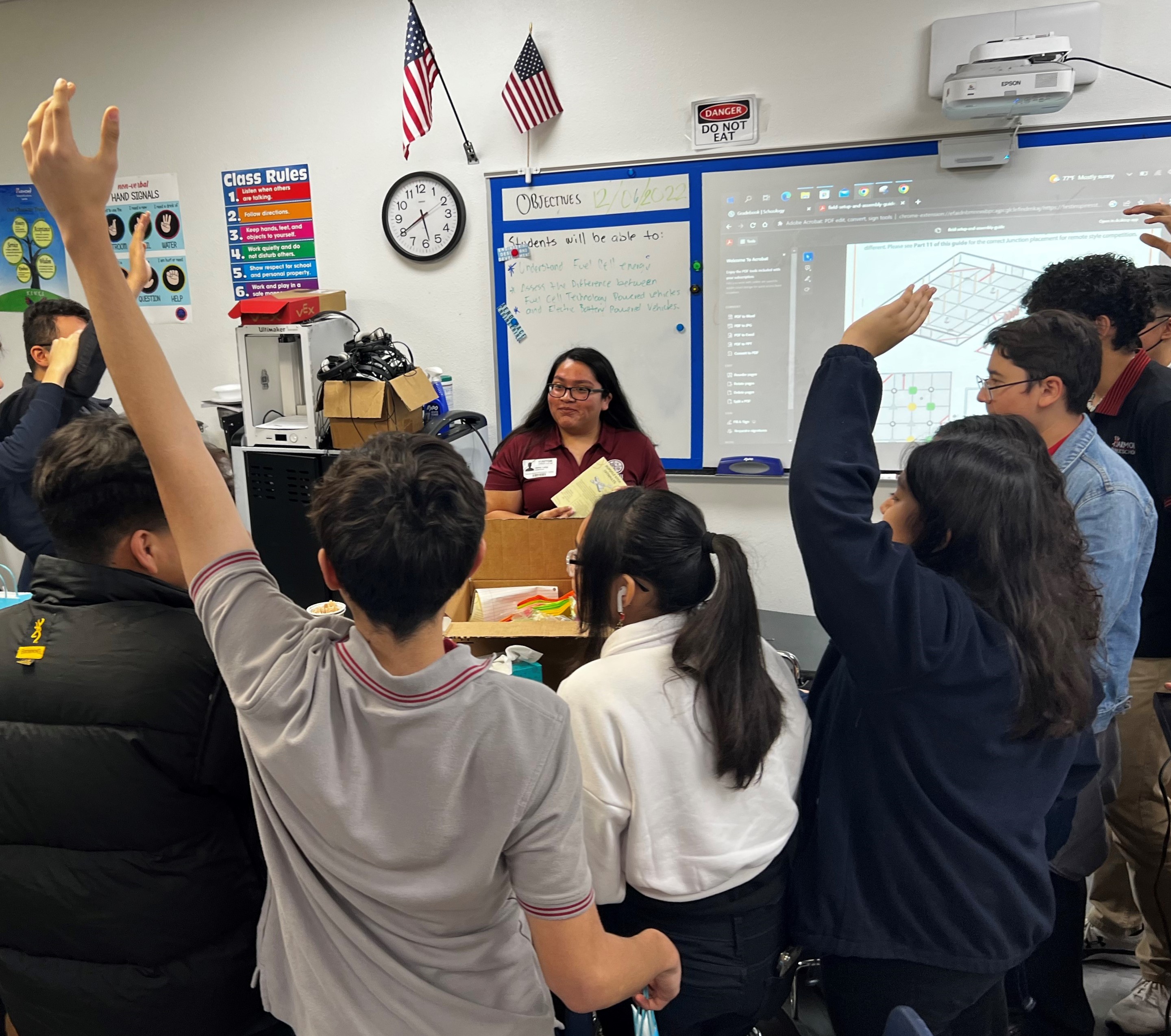 students raising their hands