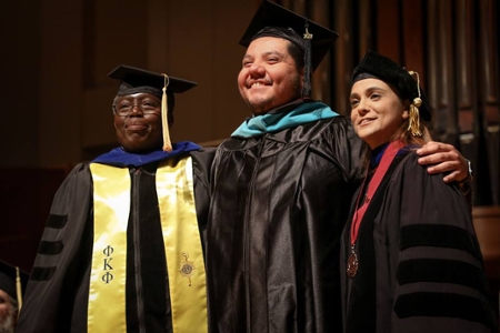 Graduate Student Hooded with Faculty.