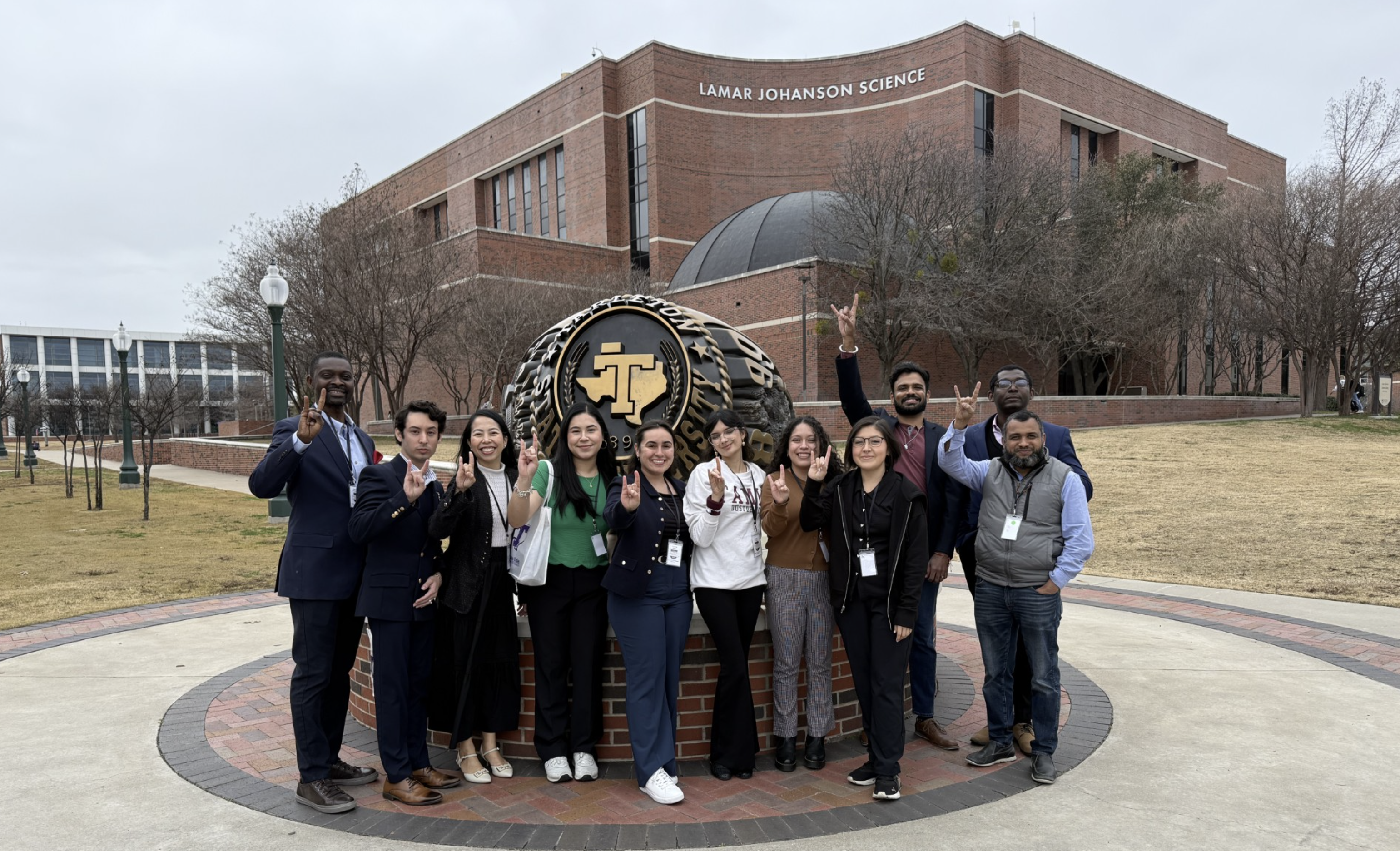 TAMIU graduate students stand together