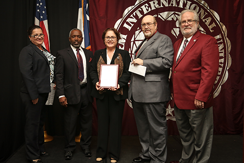 Image of Dr. Arenaz presenting award to Dr. Lourdes Viloria