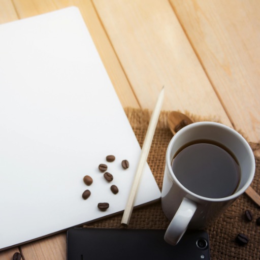 Notepad with a pencil and coffee 