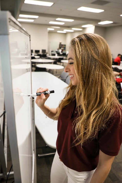 student working on whiteboard